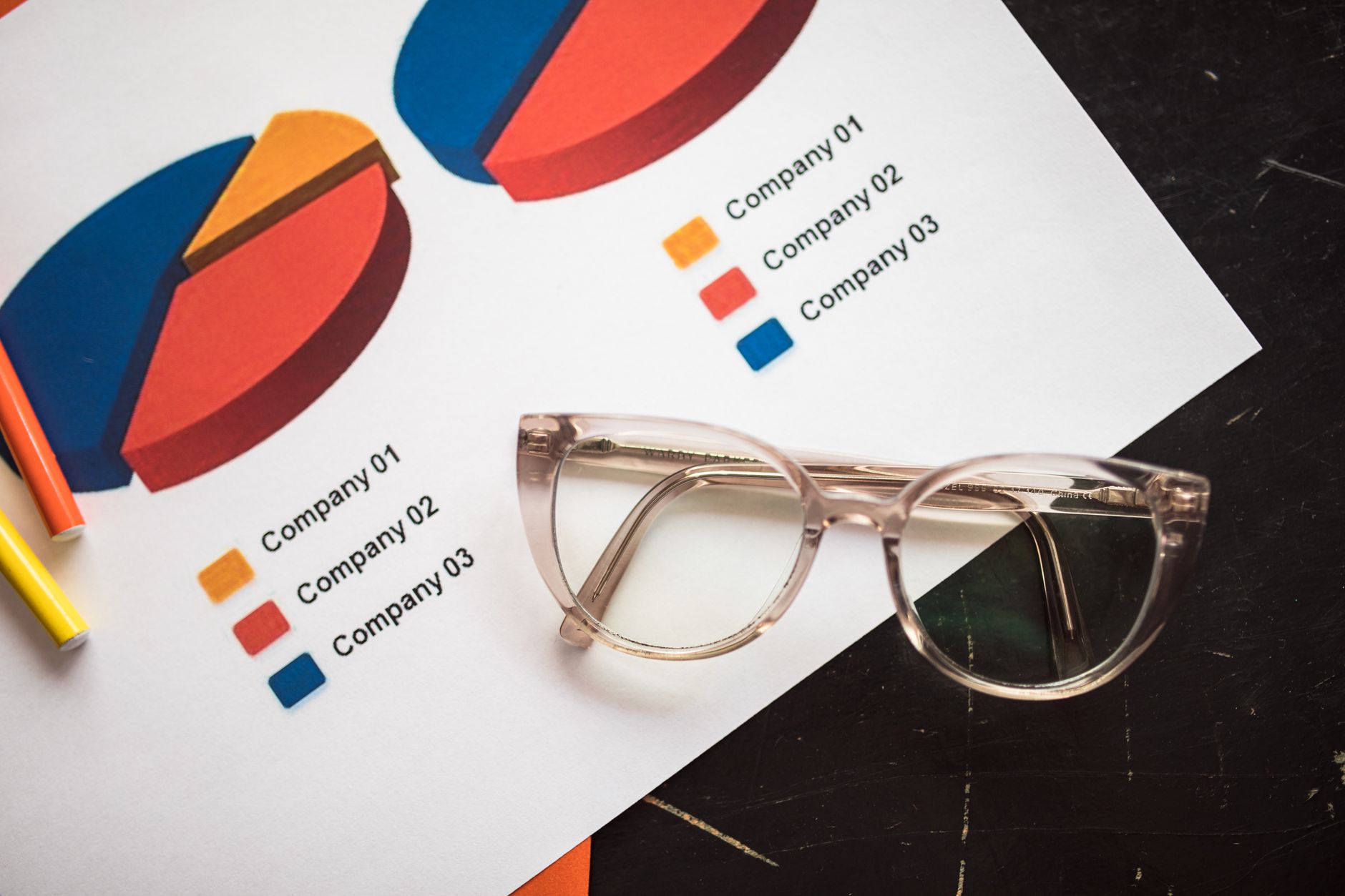 Photo of business charts and eyeglasses on a desk, ideal for finance and analytics themes.